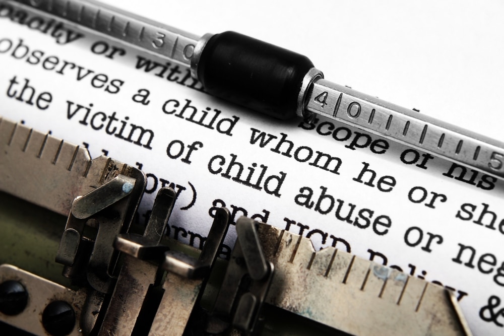 Wallace-Law-Services-09 Close up text on paper in a type writer focused on the words victim of child abuse